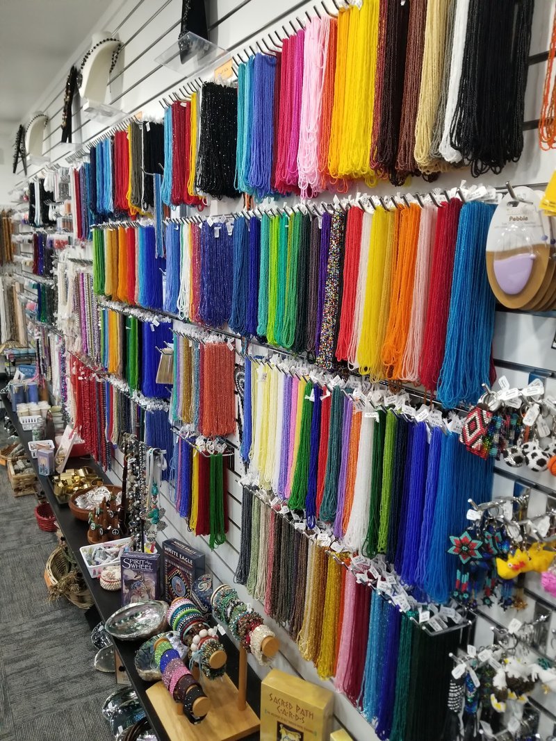 Wall with an assortment of bead necklaces made of different crystals and colors