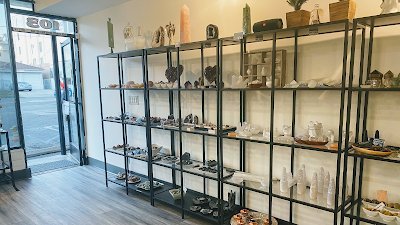 Display case of amethyst hearts, druse crystals, and towers