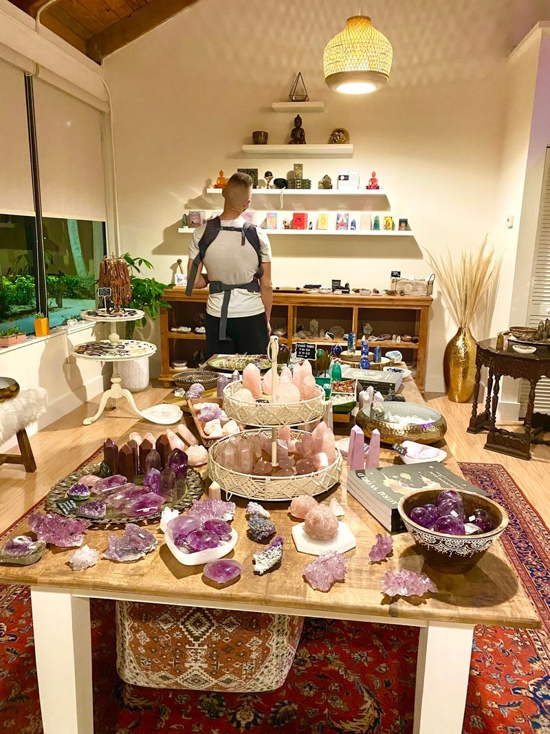 Display table containing a book on crystals surrounded by different quartz