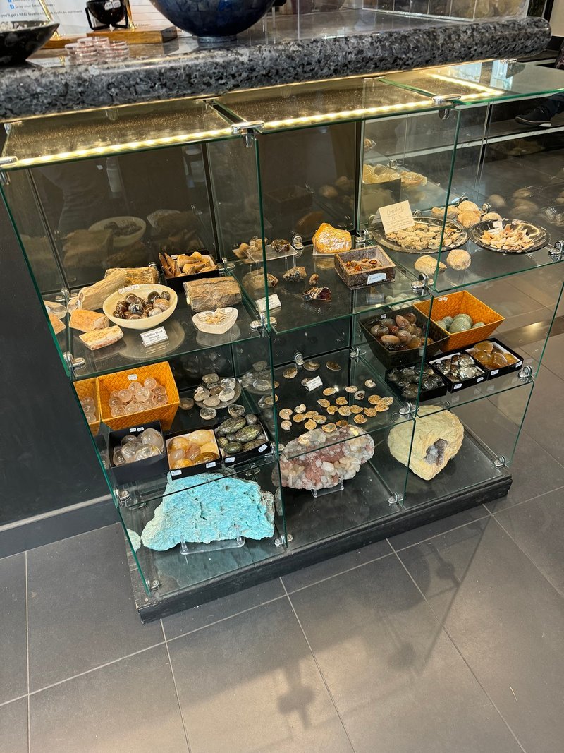 Organized crystal display with labeled stones and healing minerals