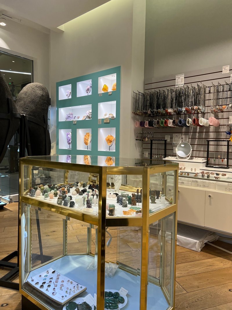 Organized crystal display with labeled stones and healing minerals