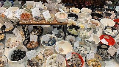 Crystal specimens and minerals displayed with spiritual and metaphysical items