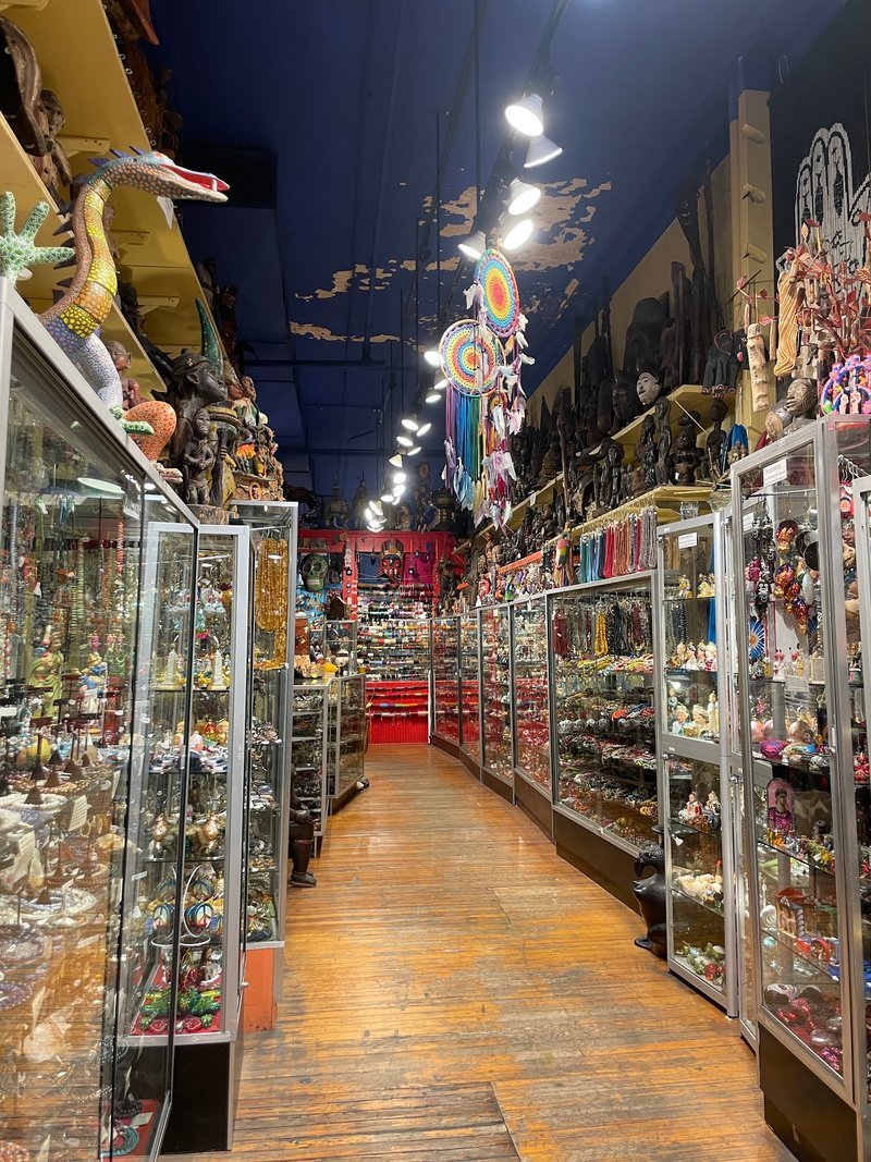 Shelving display featuring amethyst, quartz, and various crystal specimens