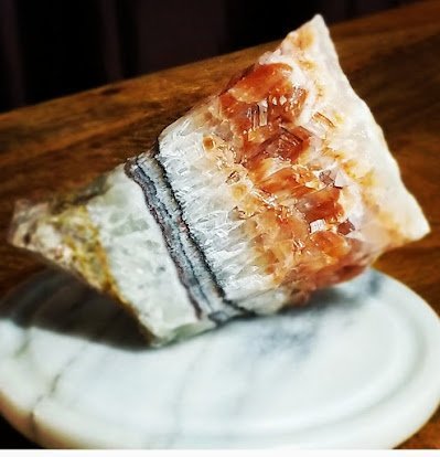 Display of crystal jewelry, tumbled stones, and carved gemstone pieces