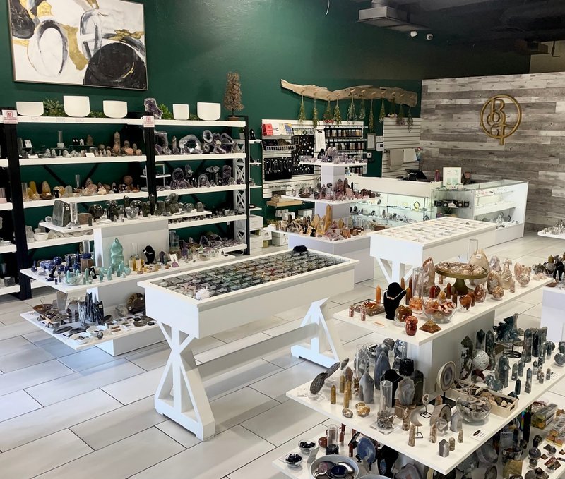 Shelving display featuring amethyst, quartz, and various crystal specimens