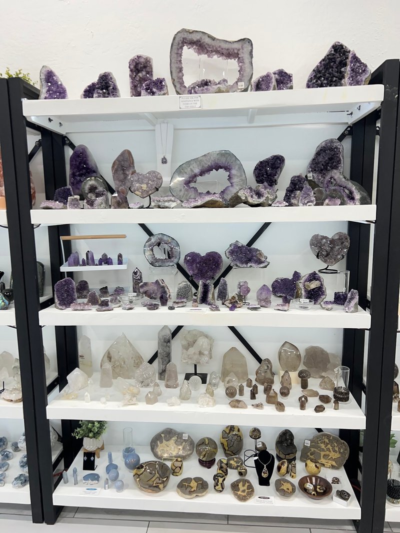 Selection of healing crystals, tumbled stones, and decorative mineral pieces