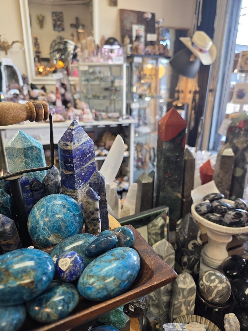 Collection of tumbled stones, raw minerals, and crystal clusters