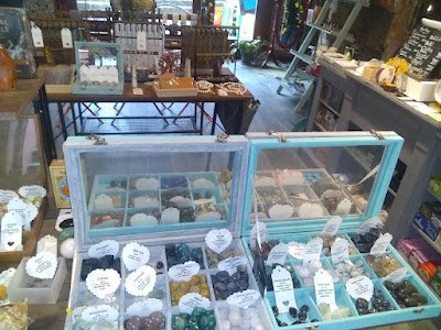 Display featuring crystal points, polished stones, and raw mineral specimens