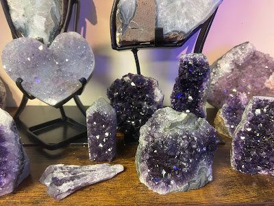 Variety of gemstones, crystal carvings, and polished mineral specimens