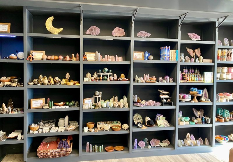 Shelving display featuring amethyst, quartz, and various crystal specimens