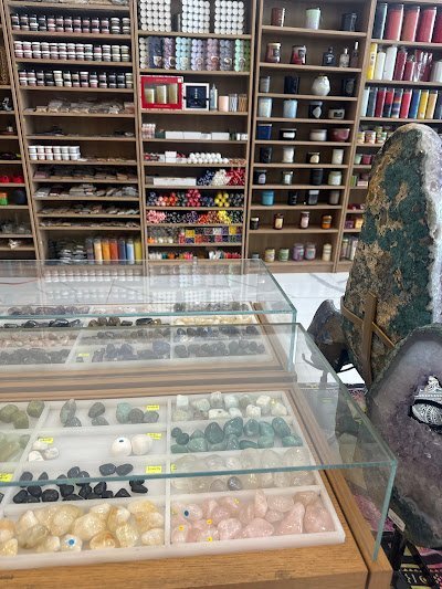 Shelving display featuring amethyst, quartz, and various crystal specimens