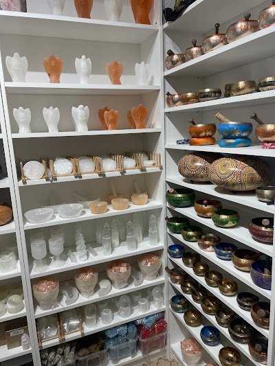 Retail shelving with organized crystals, stones, and spiritual products