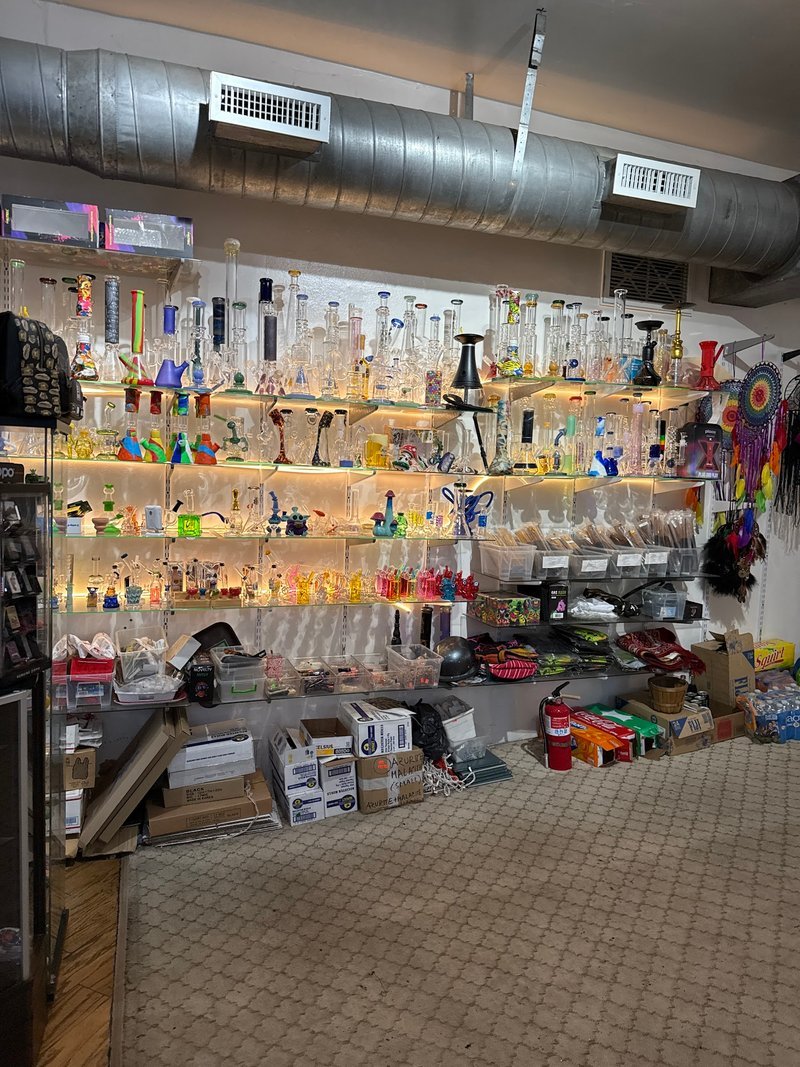 Shelving display featuring amethyst, quartz, and various crystal specimens