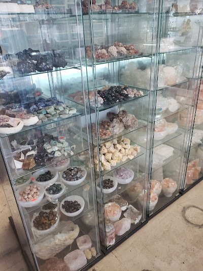 Variety of gemstones, crystal carvings, and polished mineral specimens