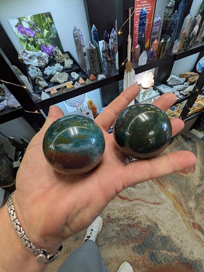 Crystal specimens and minerals displayed with spiritual and metaphysical items