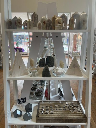 Variety of gemstones, crystal carvings, and polished mineral specimens