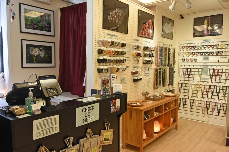 Shelving display featuring amethyst, quartz, and various crystal specimens