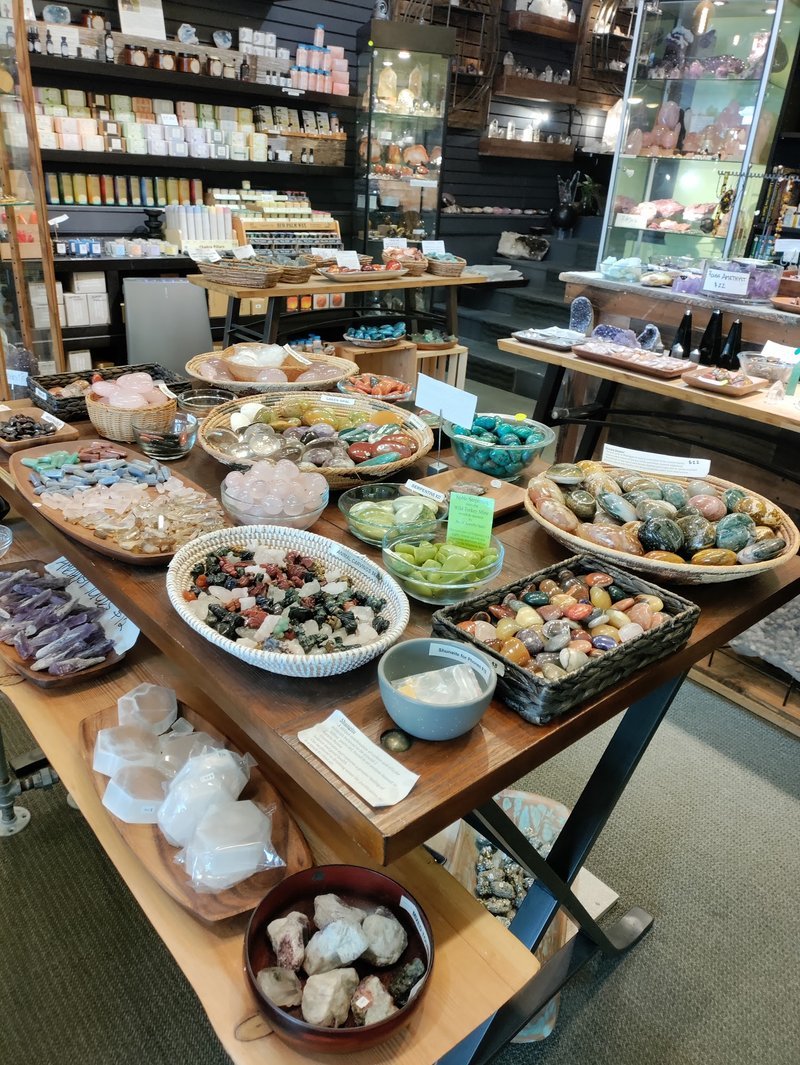 Variety of gemstones, crystal carvings, and polished mineral specimens