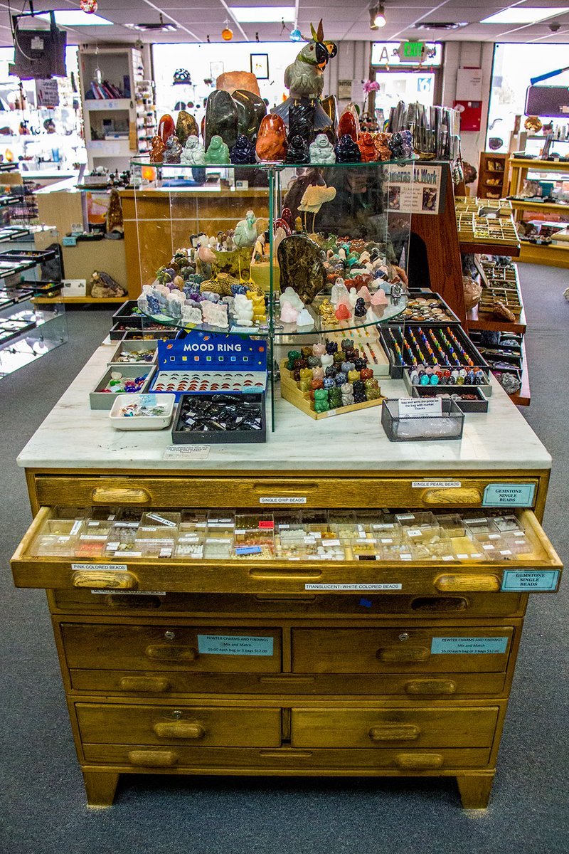 Retail shelving with organized crystals, stones, and spiritual products