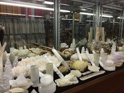 Display featuring crystal points, polished stones, and raw mineral specimens