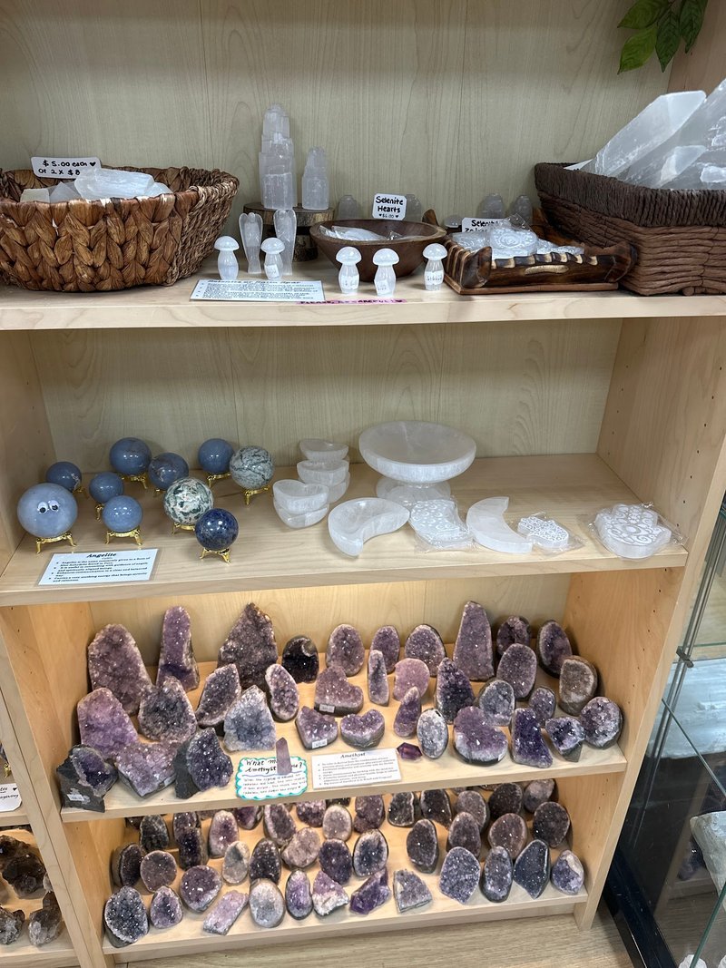 Variety of gemstones, crystal carvings, and polished mineral specimens