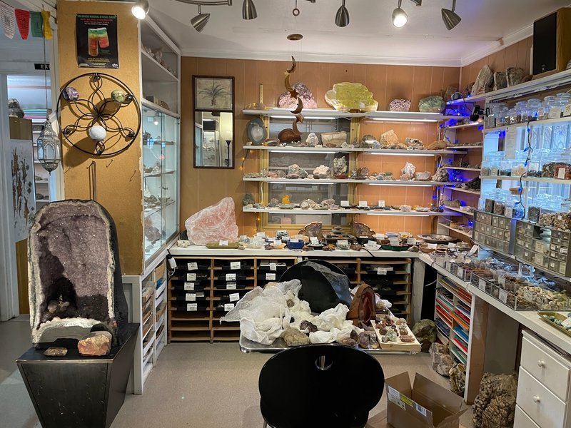 Organized crystal display with labeled stones and healing minerals