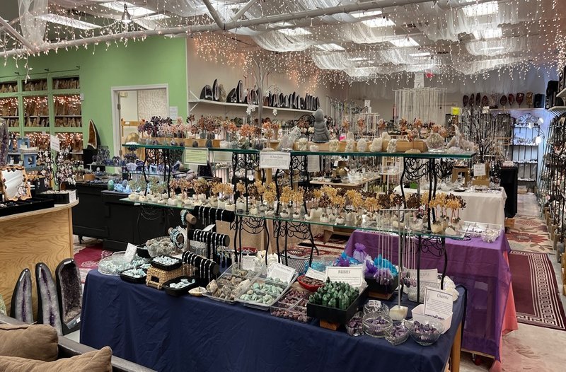 Collection of tumbled stones, raw minerals, and crystal clusters