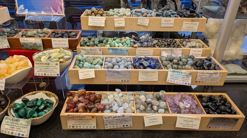 Shelving display featuring amethyst, quartz, and various crystal specimens