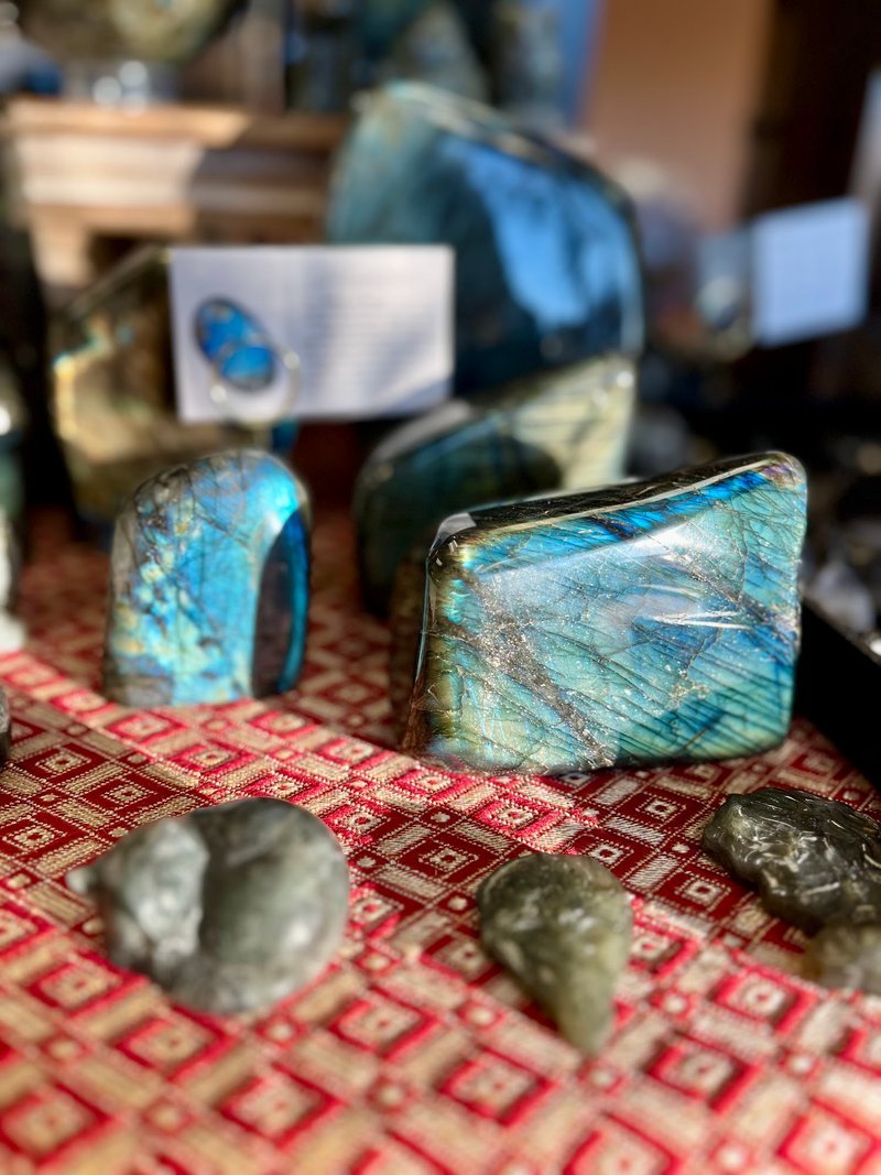 Display featuring crystal points, polished stones, and raw mineral specimens