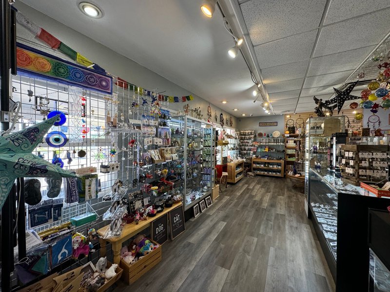 Shelving display featuring amethyst, quartz, and various crystal specimens