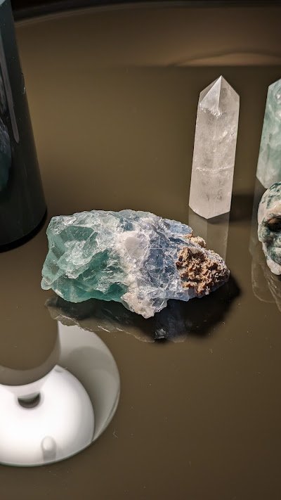 Retail shelving with organized crystals, stones, and spiritual products