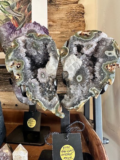 Collection of tumbled stones, raw minerals, and crystal clusters