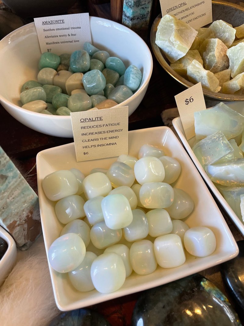 Display featuring crystal points, polished stones, and raw mineral specimens