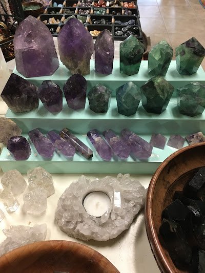 Shelving display featuring amethyst, quartz, and various crystal specimens