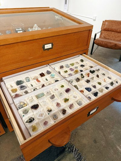 Collection of tumbled stones, raw minerals, and crystal clusters