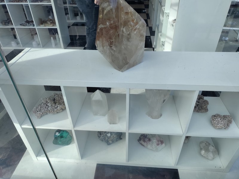 Retail shelving with organized crystals, stones, and spiritual products