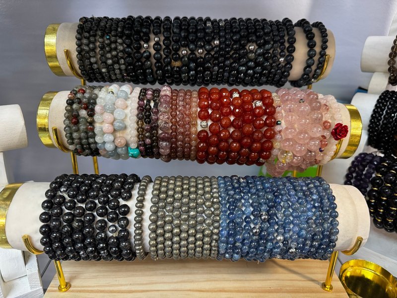 Shelving display featuring amethyst, quartz, and various crystal specimens
