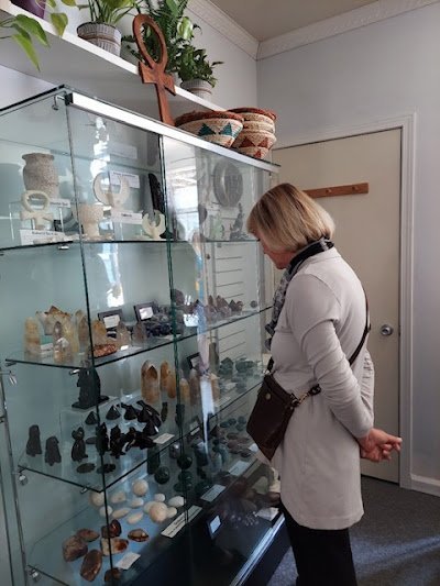 Variety of gemstones, crystal carvings, and polished mineral specimens