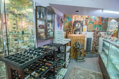 Display featuring crystal points, polished stones, and raw mineral specimens
