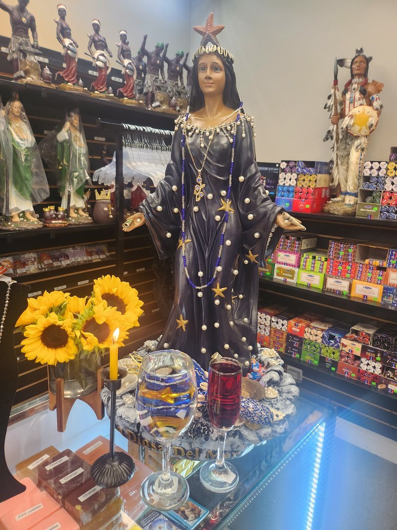 Variety of gemstones, crystal carvings, and polished mineral specimens