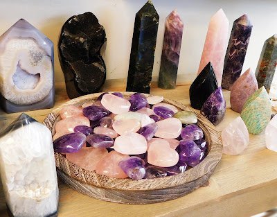 Display featuring crystal points, polished stones, and raw mineral specimens
