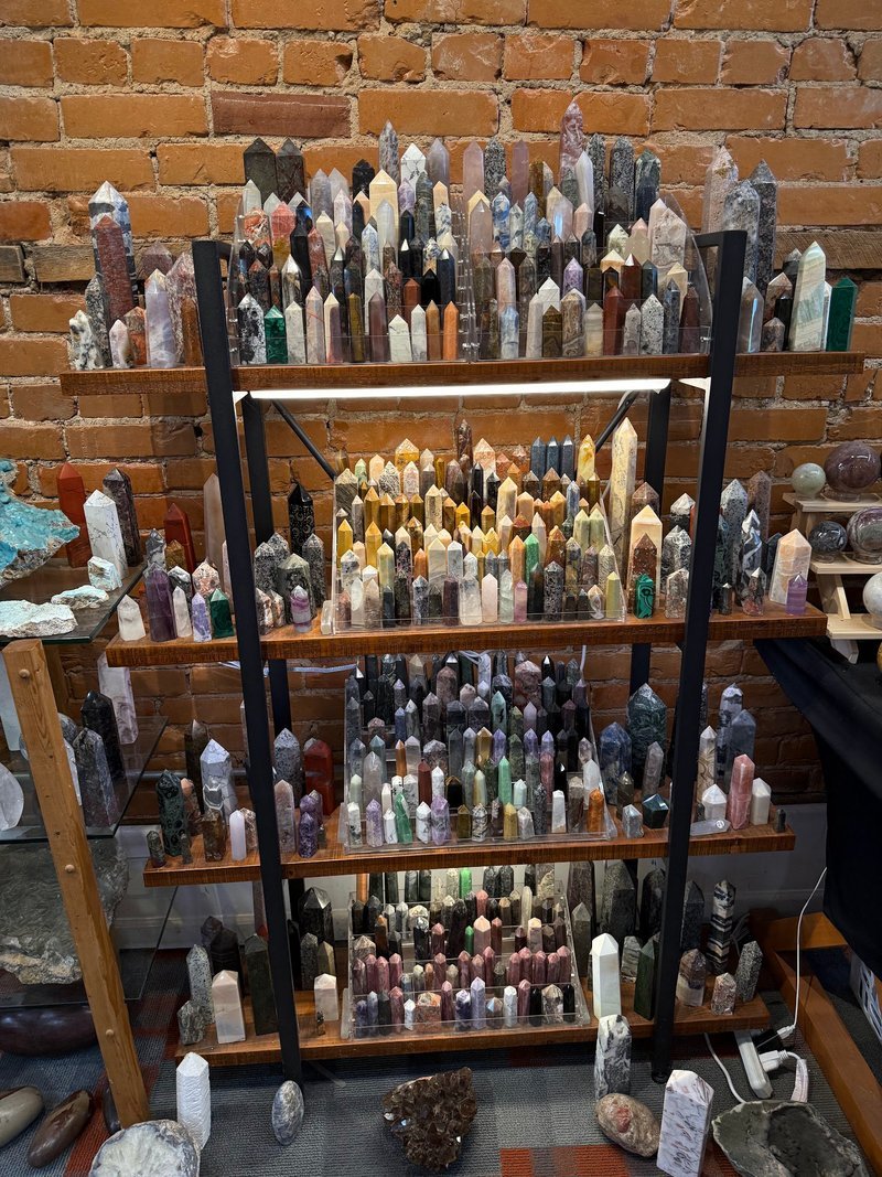 Display of polished crystal specimens, geodes, and mineral towers