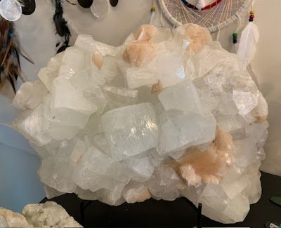 Display featuring crystal points, polished stones, and raw mineral specimens