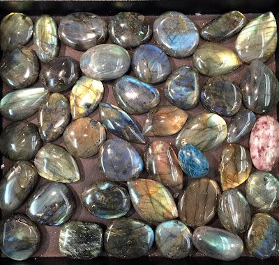 Organized crystal display with labeled stones and healing minerals