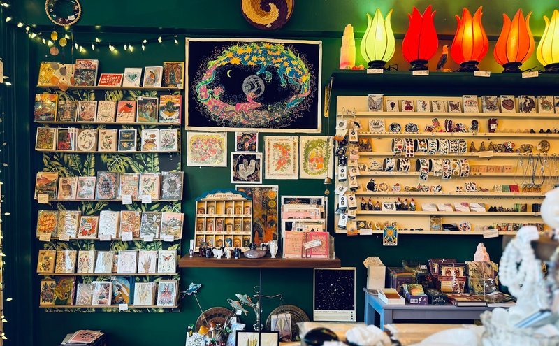 Shelving display featuring amethyst, quartz, and various crystal specimens