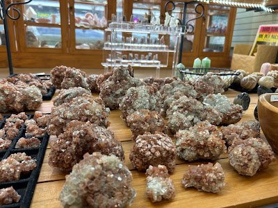 Collection of tumbled stones, raw minerals, and crystal clusters