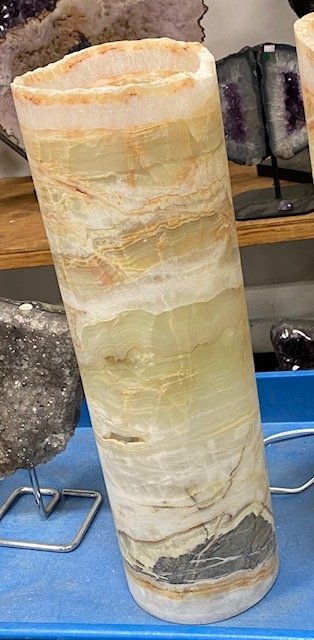 Shelving display featuring amethyst, quartz, and various crystal specimens