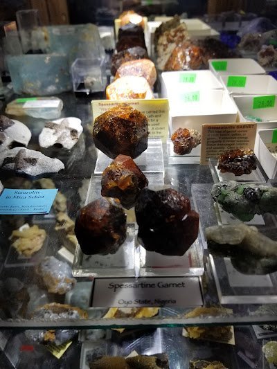 Display featuring crystal points, polished stones, and raw mineral specimens