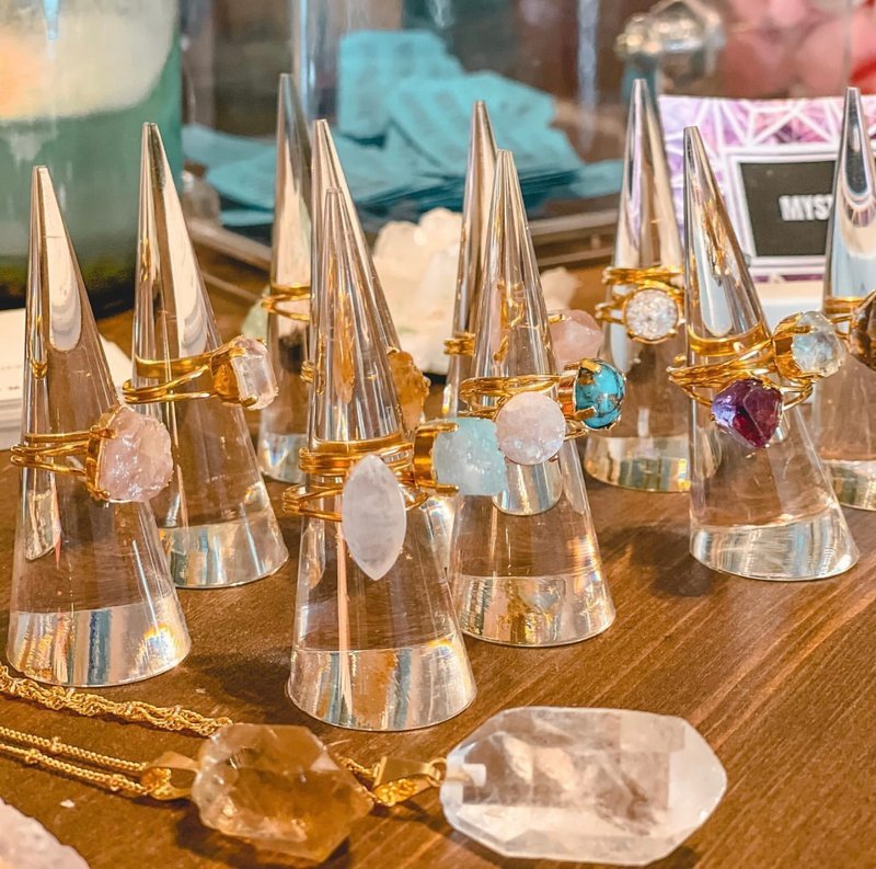 Display featuring crystal points, polished stones, and raw mineral specimens