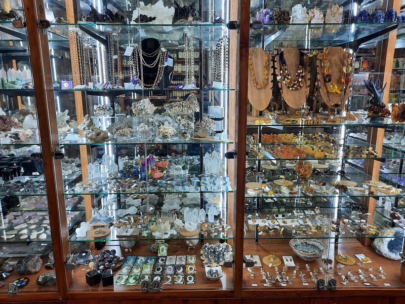 Retail shelving with organized crystals, stones, and spiritual products